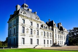 Cheverny Castle in France basking in sunlight with clear blue skies.